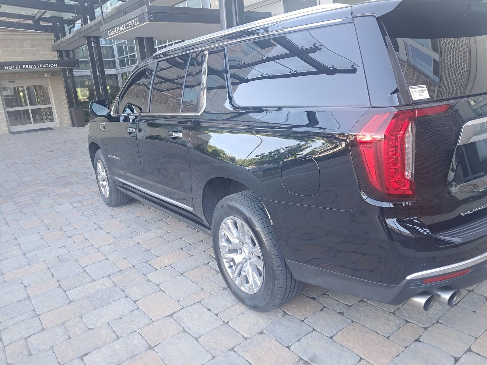 Black luxury SUV parked on pavers