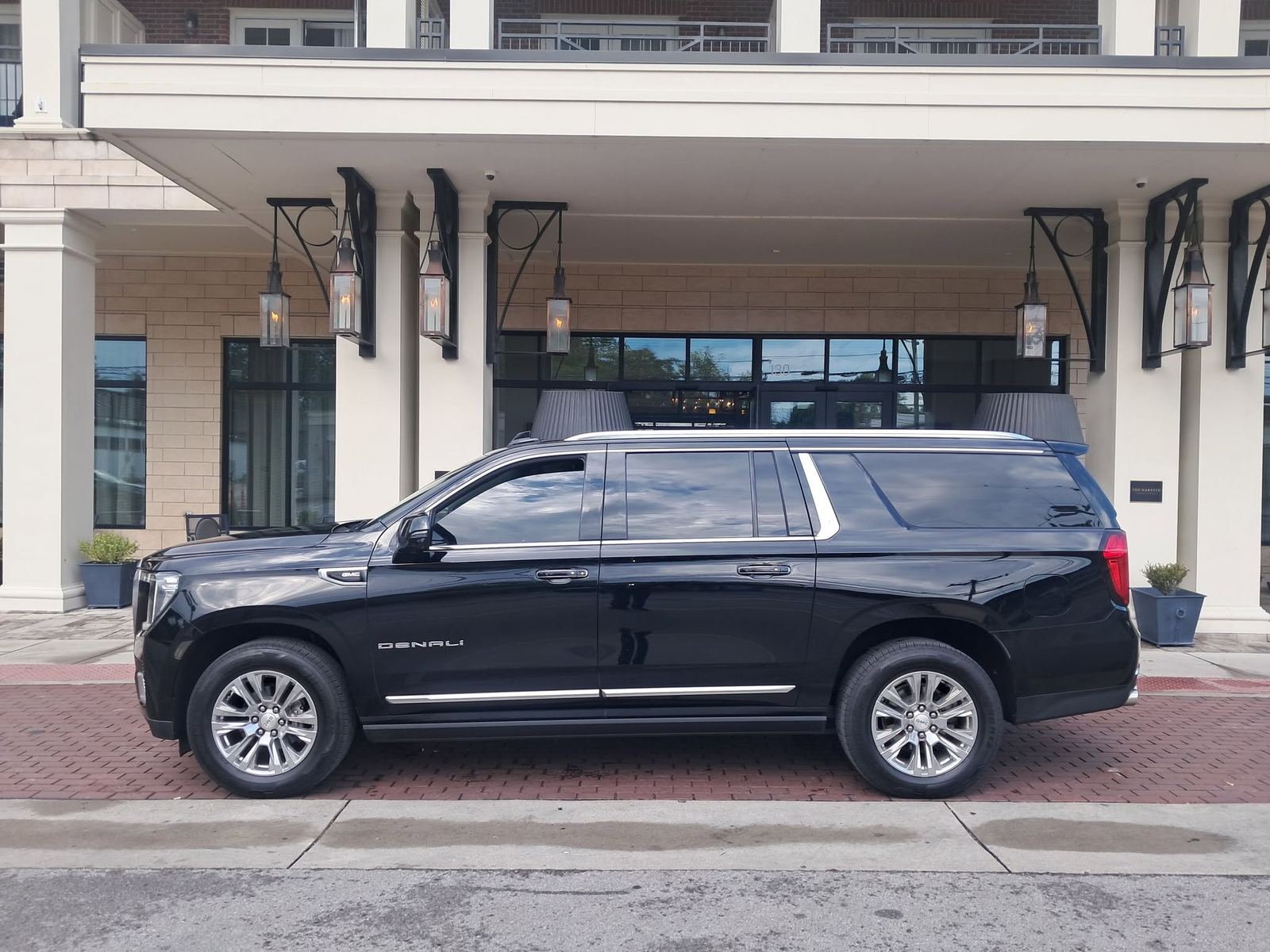 luxury SUV at a hotel entrance