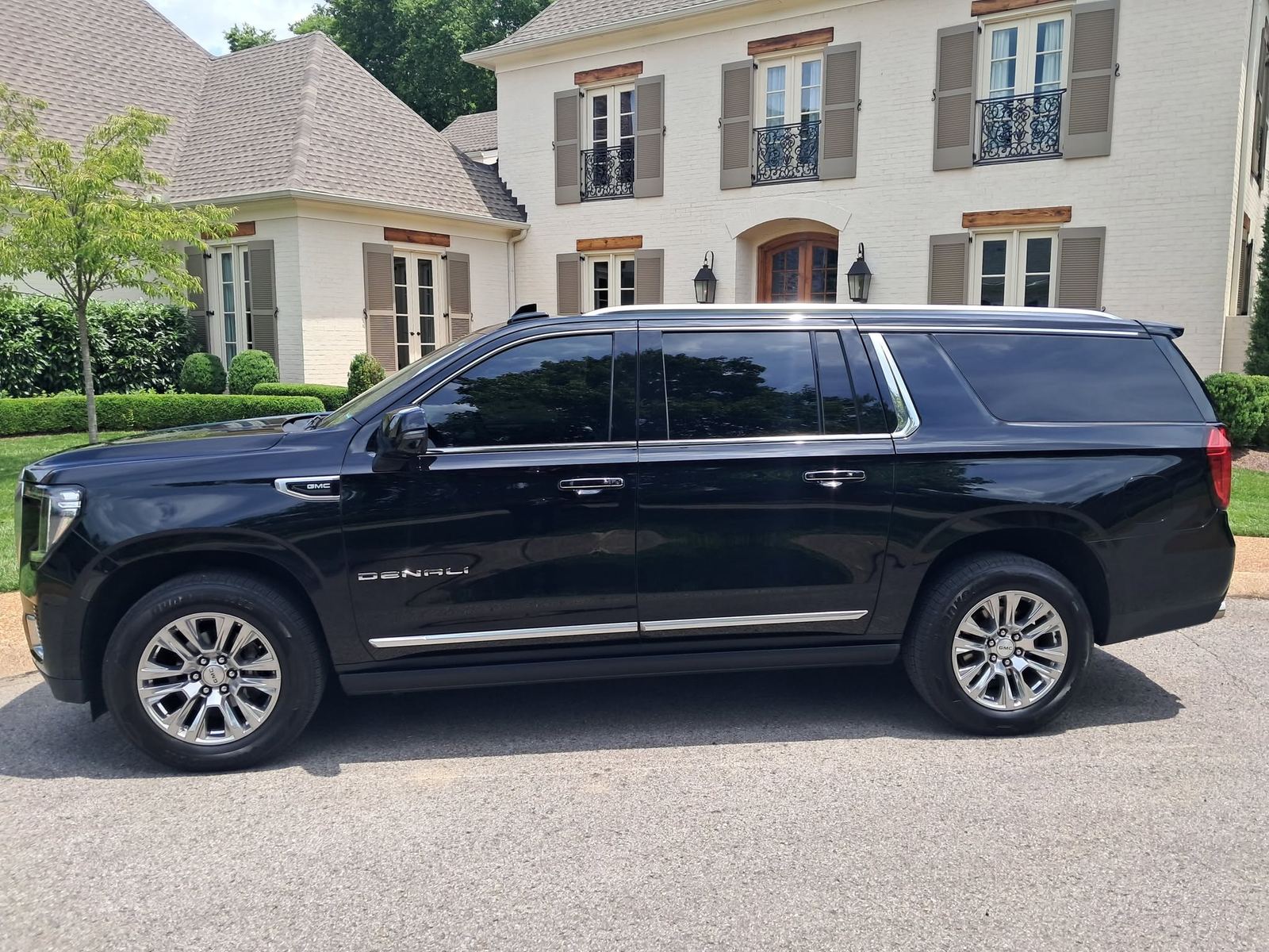 Black luxury SUV parked outside a home